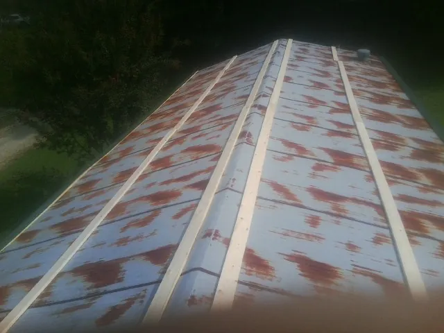 Rusted metal roof panels with new wood purlins before replacement — Storm Damage Roof Repair in Hollywood by Roofing Brothers